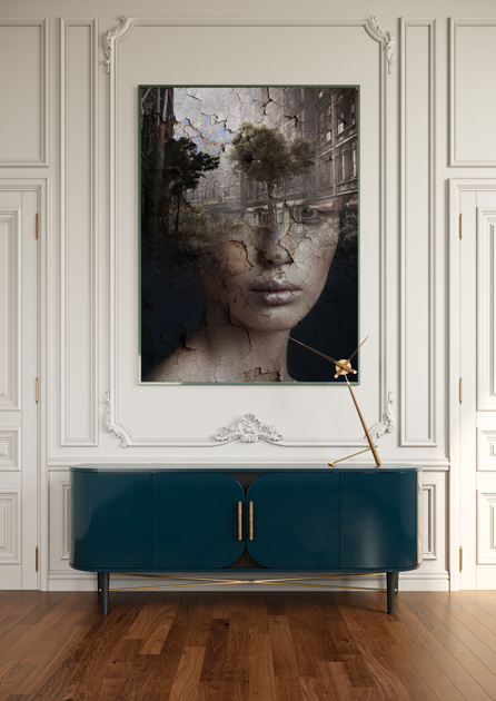 Image description: Decoration and art with woman's face cast with garden over blue sideboard