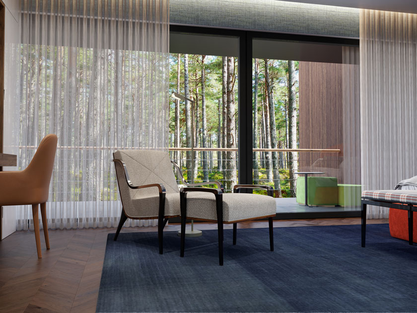 Image description: reading corner in a room with beige armchair, with matching footstool