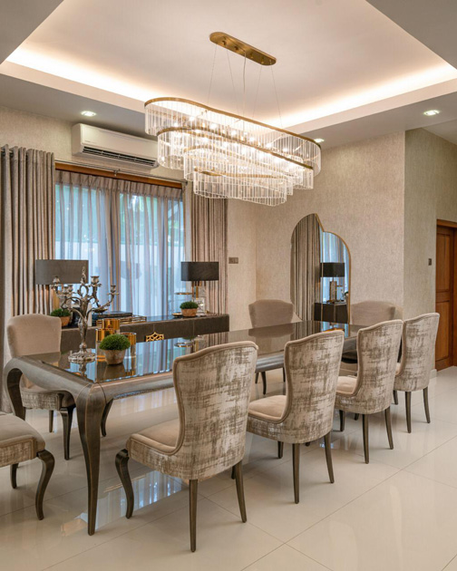 Image Description: Vertical decorative mirror in a dining room, of symmetric geometric shapes.